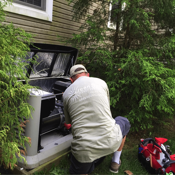 “Green Sun Energy Services technician performing scheduled maintenance on a Generac standby generator